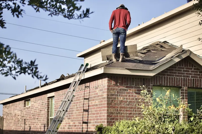 Professional roofer working on a residential roof in Wood Creek Farms